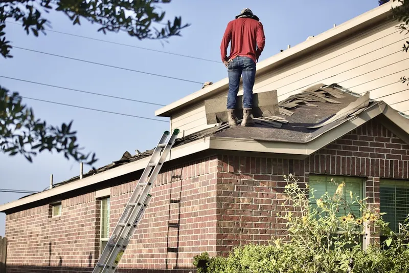Professional roofer working on a residential roof in Roosevelt Place East
